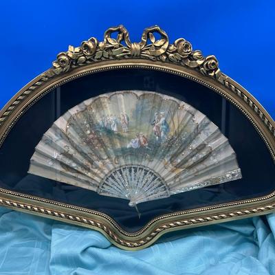 Sale Photo Thumbnail #405: Hand painted silk fan with etched mother of pearl, French courting  scene.  In a beautiful gold tone shadowbox, 23 x 15 inches.  
Retails at $300-$500