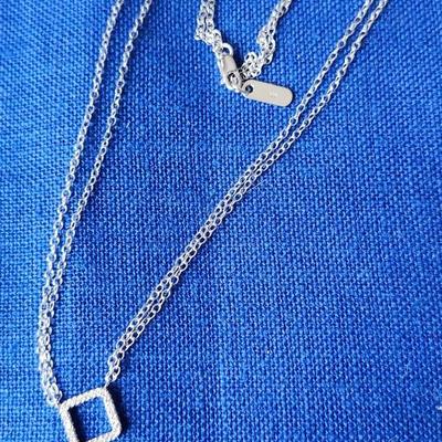 Sale Photo Thumbnail #417: 14 K gold stamped pendant with diamonds.
The 16 inch double  chain is not marked, likely sterling