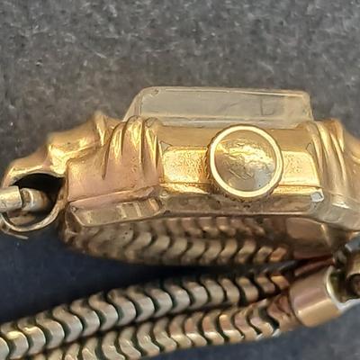 vintage Bulova ladies' watch, likely from the 1940s to 1960s, with a 10k gold-filled case and a manual wind-up movement. 12 k gf