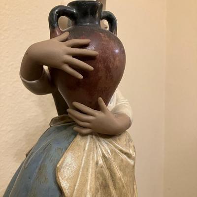 Sale Photo Thumbnail #113: Lladro figurine featuring "In search of water", measuring 15" H. All fingers are intact.
