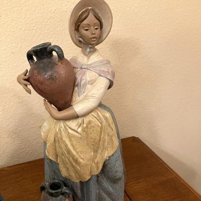 Sale Photo Thumbnail #112: Lladro figurine featuring "In search of water", measuring 15" H. All fingers are intact.