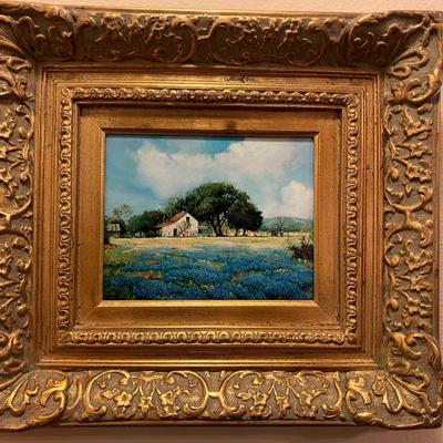 Sale Photo Thumbnail #149: Betty Lou Voorhis oil on canvas, bluebonnet scene with farmhouse. Numbered 7/50. Measures 18" H x 20" W in golden frame