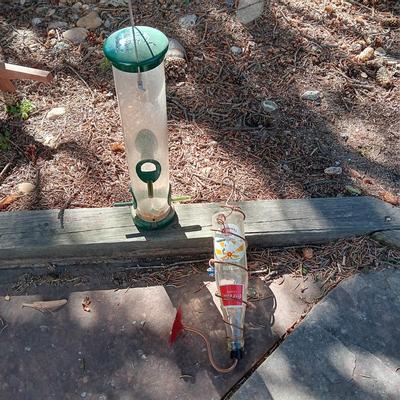 WILD BIRDS UNLIMITED FEEDER AND A COCA-COLA HUMMINGBIRD FEEDER