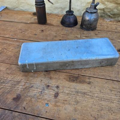 Three vintage metal oil cans with spouts and a metal tray
