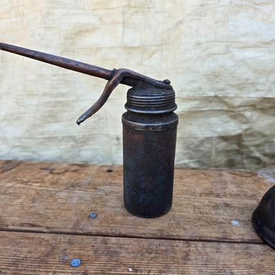 Three vintage metal oil cans with spouts and a metal tray