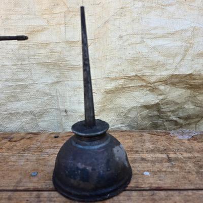 Three vintage metal oil cans with spouts and a metal tray