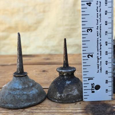 Four vintage oil cans - 2 small thumb press dome cans and 2 larger