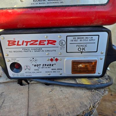 Two Blitzer Electric fence chargers with electric fence insulators / fencing items and spool of repair wire