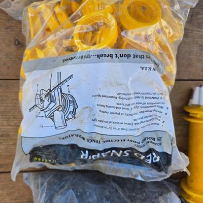 Two Blitzer Electric fence chargers with electric fence insulators / fencing items and spool of repair wire
