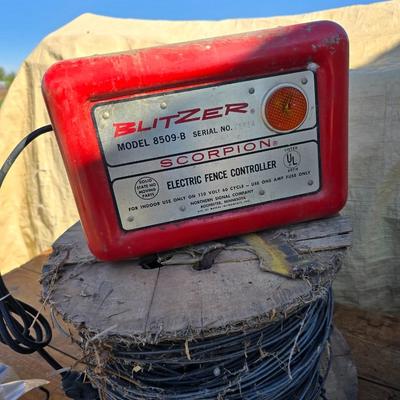 Two Blitzer Electric fence chargers with electric fence insulators / fencing items and spool of repair wire