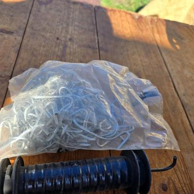Two Blitzer Electric fence chargers with electric fence insulators / fencing items and spool of repair wire