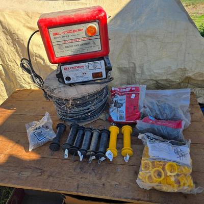 Two Blitzer Electric fence chargers with electric fence insulators / fencing items and spool of repair wire