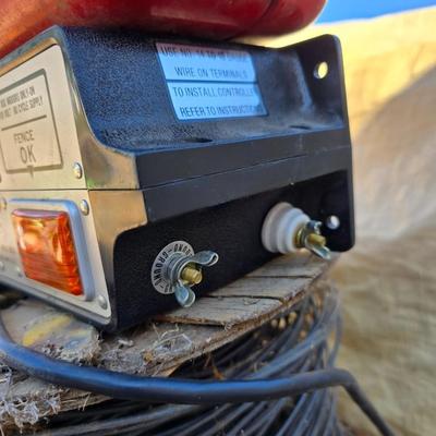 Two Blitzer Electric fence chargers with electric fence insulators / fencing items and spool of repair wire