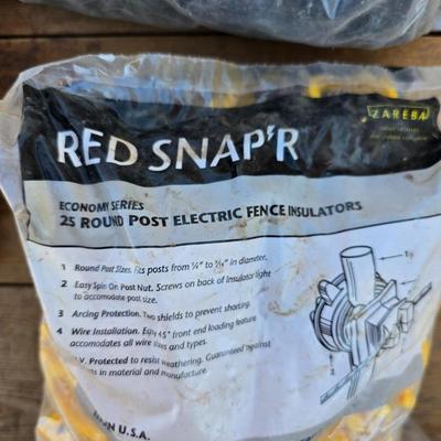 Two Blitzer Electric fence chargers with electric fence insulators / fencing items and spool of repair wire