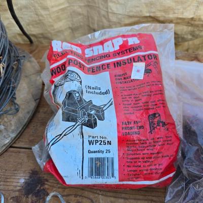 Two Blitzer Electric fence chargers with electric fence insulators / fencing items and spool of repair wire
