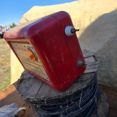 Two Blitzer Electric fence chargers with electric fence insulators / fencing items and spool of repair wire