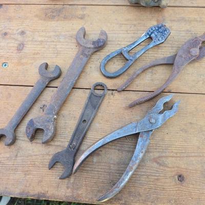 Antique porcelain insulators - cast iron - wrenches - and other rustic farm items for the side of the farm shed!