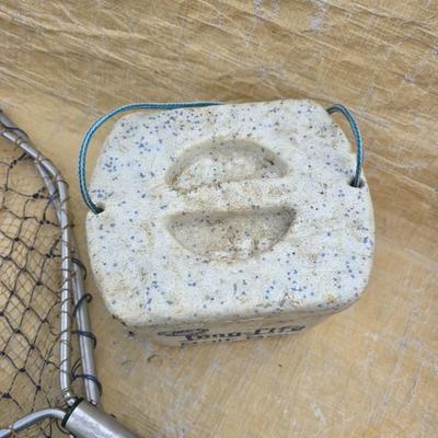 Two long, large fish nets - bob bet bait box- thermos, and a water bottle