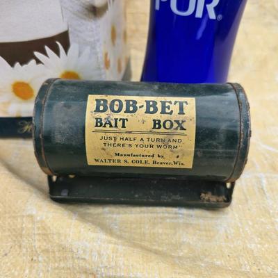 Two long, large fish nets - bob bet bait box- thermos, and a water bottle