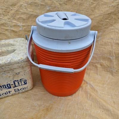Two long, large fish nets - bob bet bait box- thermos, and a water bottle