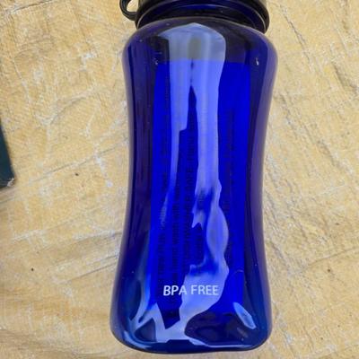Two long, large fish nets - bob bet bait box- thermos, and a water bottle