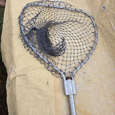 Two long, large fish nets - bob bet bait box- thermos, and a water bottle