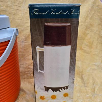 Two long, large fish nets - bob bet bait box- thermos, and a water bottle