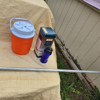 Two long, large fish nets - bob bet bait box- thermos, and a water bottle