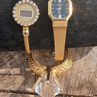Two womens watches with faux diamonds and a Big huge faux diamond ring