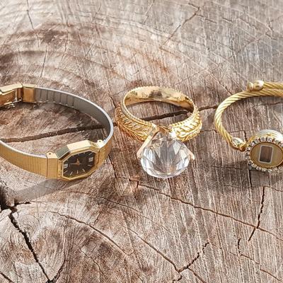 Two womens watches with faux diamonds and a Big huge faux diamond ring