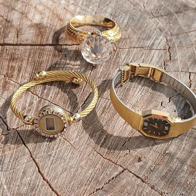 Two womens watches with faux diamonds and a Big huge faux diamond ring