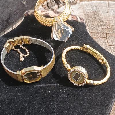 Two womens watches with faux diamonds and a Big huge faux diamond ring