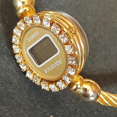 Two womens watches with faux diamonds and a Big huge faux diamond ring