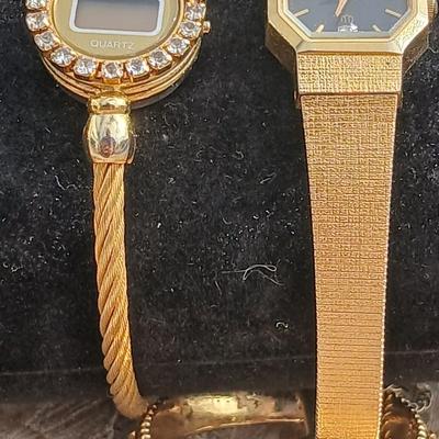 Two womens watches with faux diamonds and a Big huge faux diamond ring