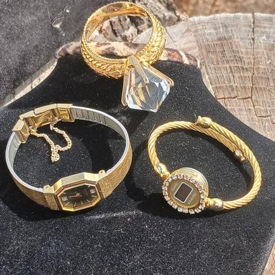 Two womens watches with faux diamonds and a Big huge faux diamond ring