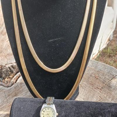 Two gold toned thick chain necklaces with a Watch - it watch