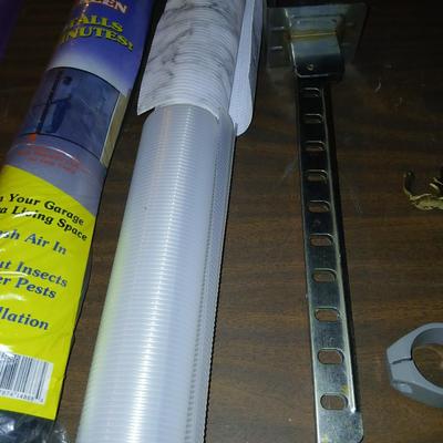 Giant garage door screen new in the package - some shelf liner - a small vise and more