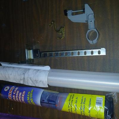Giant garage door screen new in the package - some shelf liner - a small vise and more