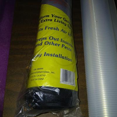 Giant garage door screen new in the package - some shelf liner - a small vise and more