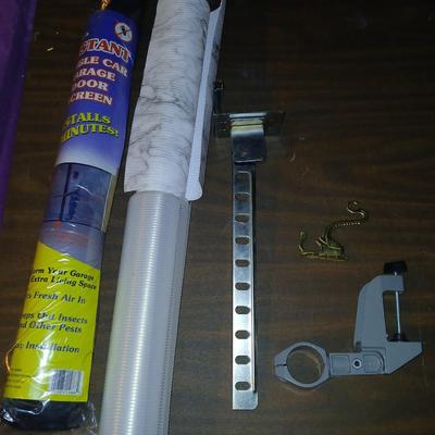 Giant garage door screen new in the package - some shelf liner - a small vise and more