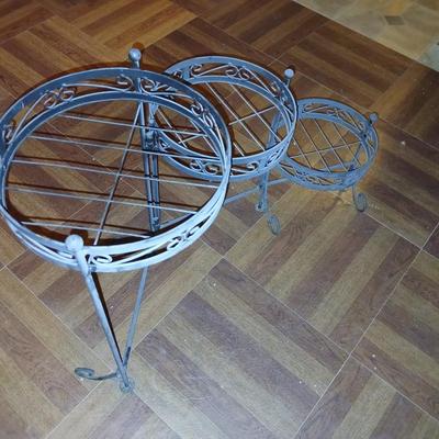 Three tiered adjustable plant stand with a larger plant stand
