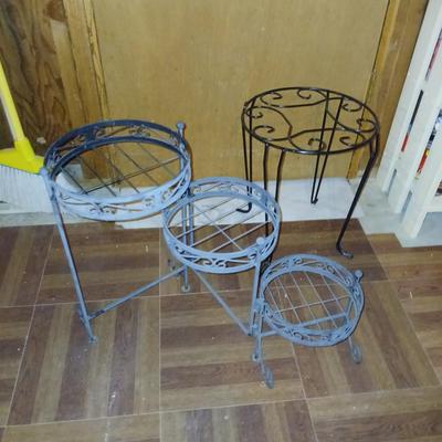 Three tiered adjustable plant stand with a larger plant stand