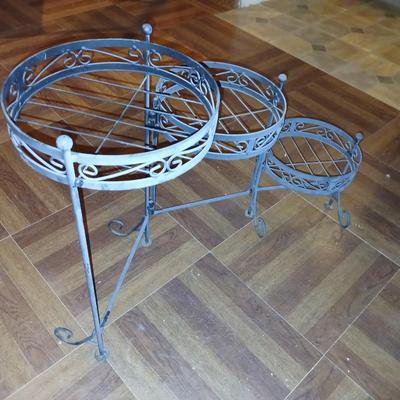Three tiered adjustable plant stand with a larger plant stand