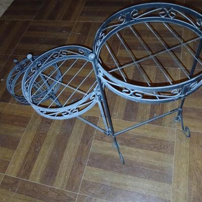 Three tiered adjustable plant stand with a larger plant stand
