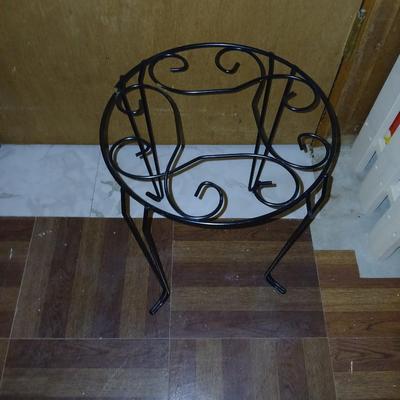 Three tiered adjustable plant stand with a larger plant stand