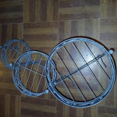 Three tiered adjustable plant stand with a larger plant stand