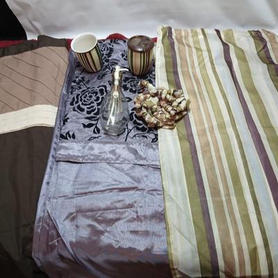 Shower curtains, small rug, and bathroom containers