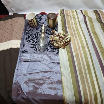 Shower curtains, small rug, and bathroom containers