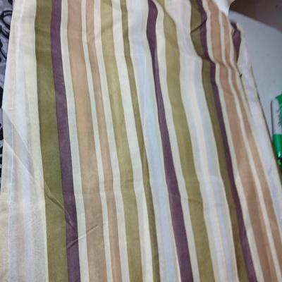 Shower curtains, small rug, and bathroom containers