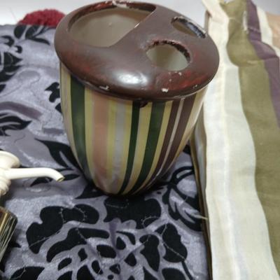 Shower curtains, small rug, and bathroom containers